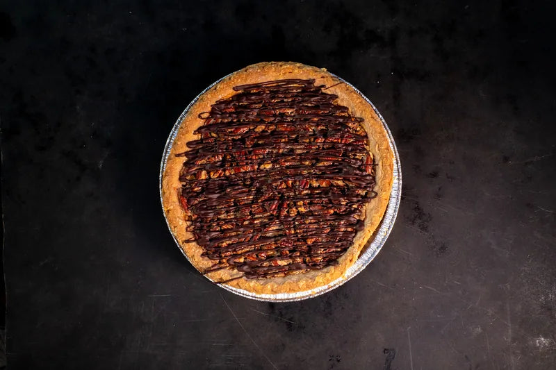 Round tart with a dark chocolate topping viewed from above