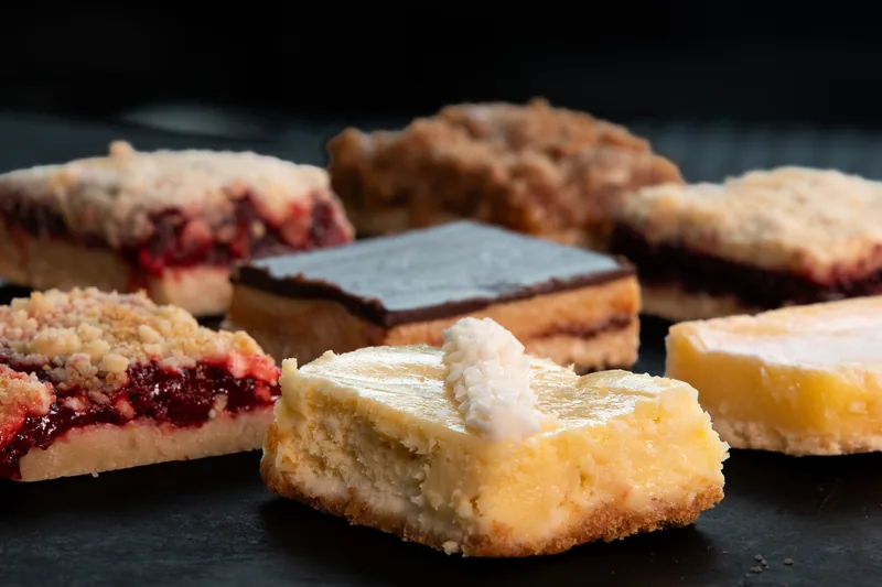 Assorted square bakery bars arranged on a serving surface