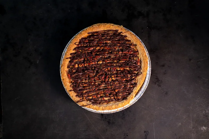 Round tart with a dark chocolate topping viewed from above