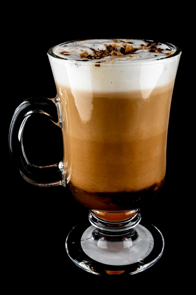 Layered iced coffee drink in a clear cup