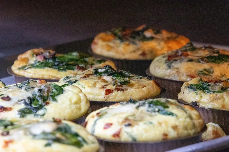 Savory pastries arranged in bakery display trays