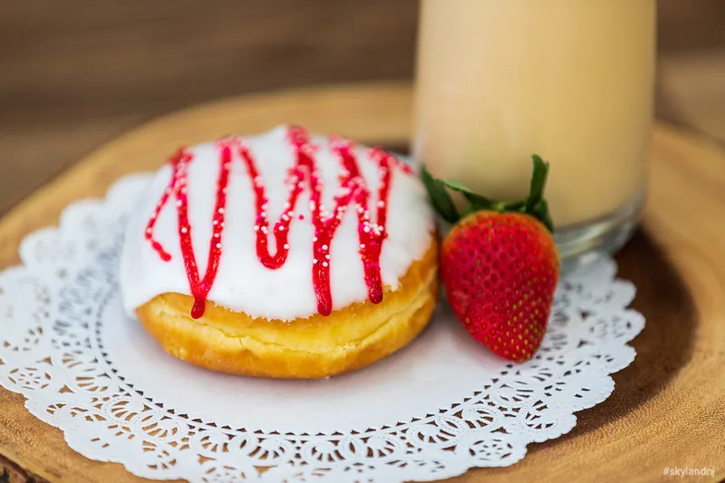 Small white cake decorated with strawberries